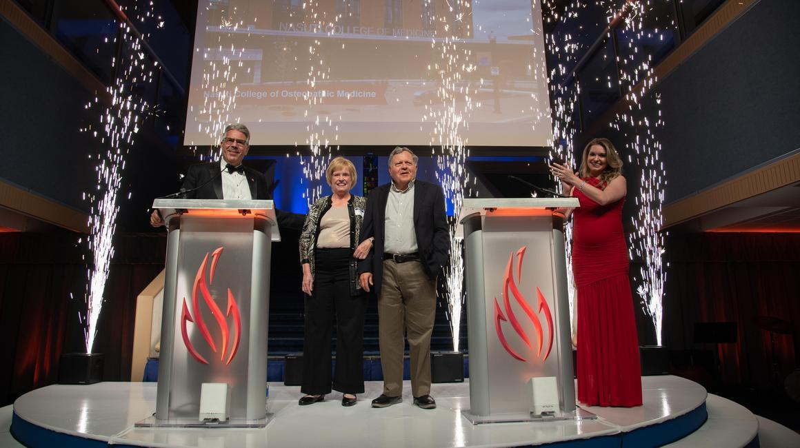 Mr. and Mrs. Nasuti with the president and fireworks during their gift announcement.