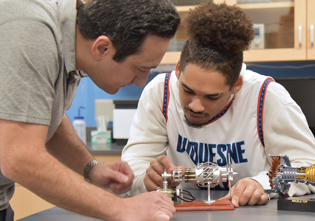 student and teacher doing experiment