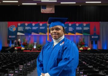 Charles Harris standing in front of commencement stage