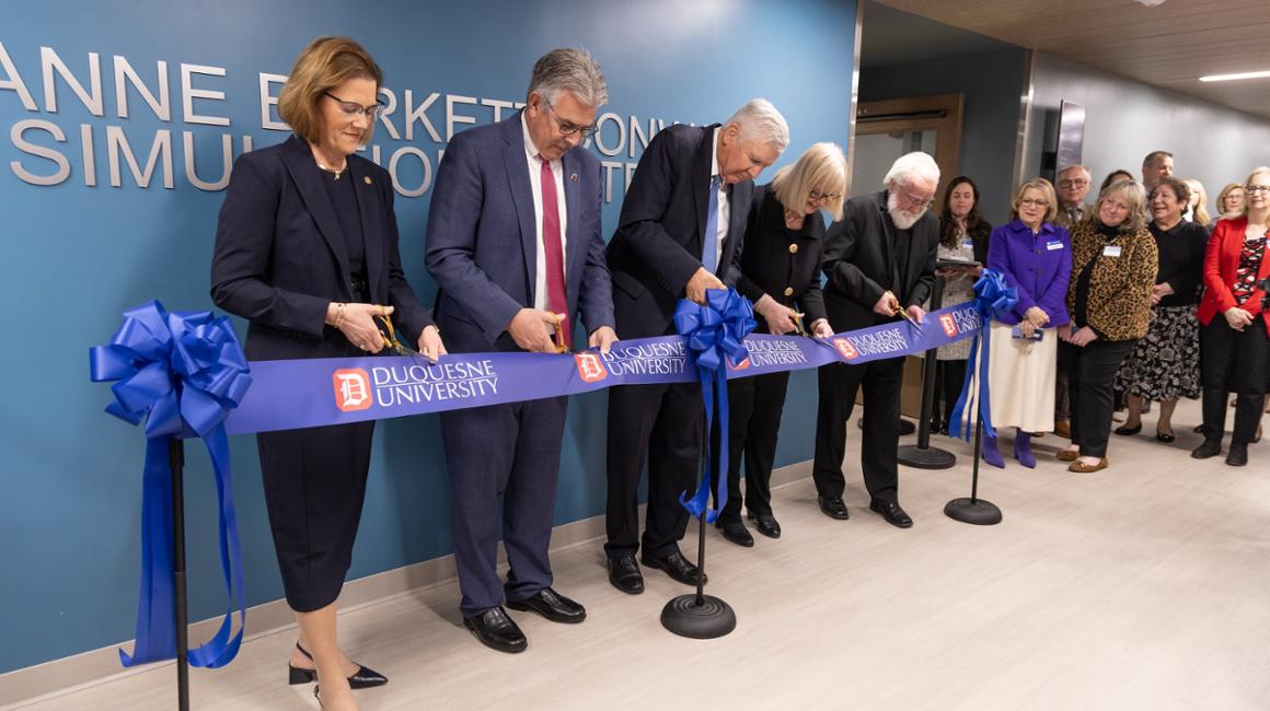 Five people cut the ribbon at event