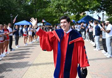President David Dausey on A-Walk waves to students.