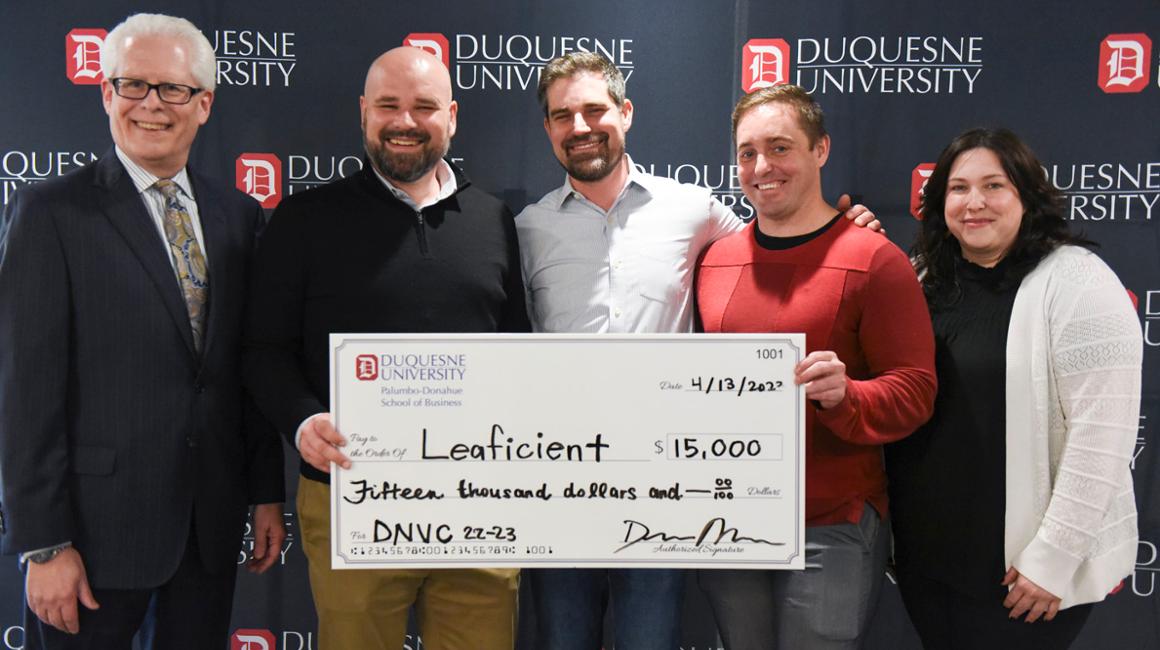 Dean McFarlin and Director Staci Offutt present the 2022-2023 DNVC winner, Leaficient, with the first-place award