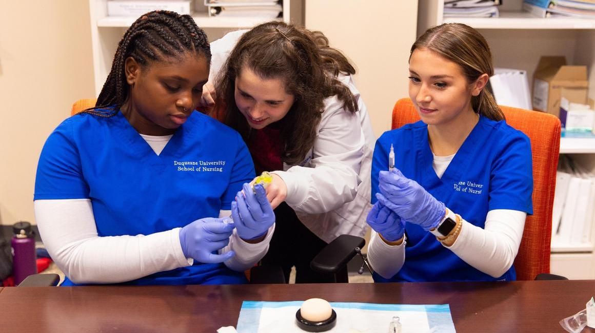 Nursing professor with 2 students