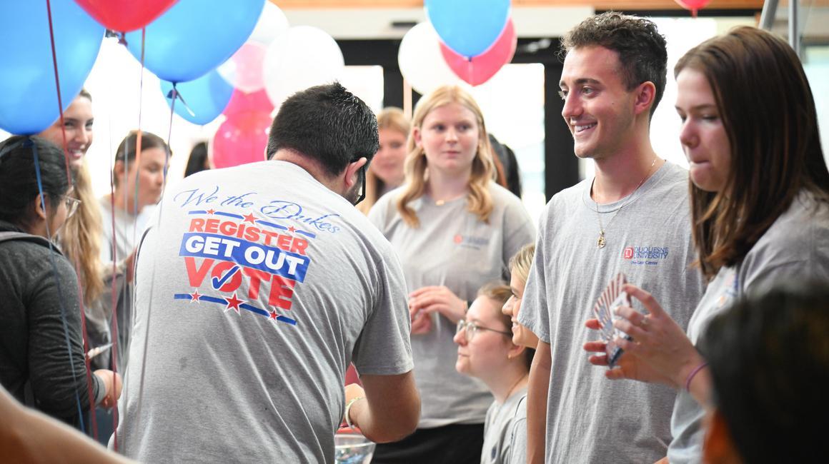 Students mingle in the Union lobby during a voter registration drive