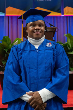 Charles Harris smiles for photo at graduation.