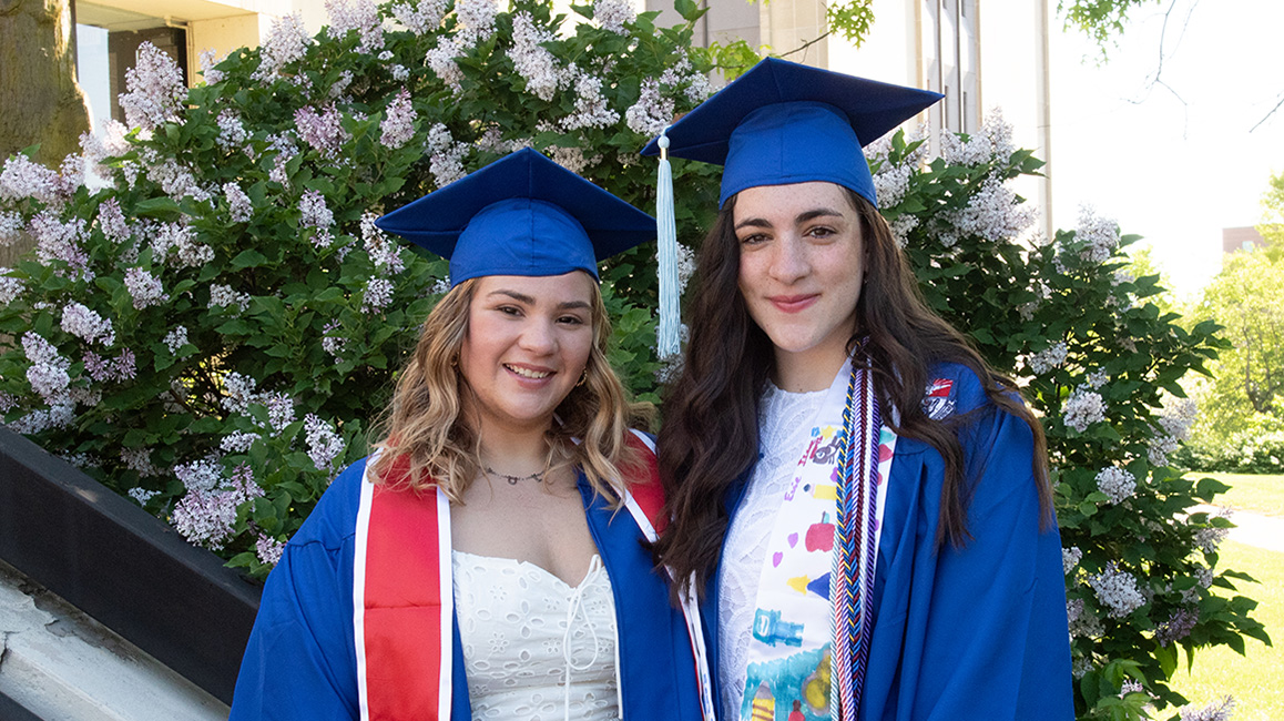 Rachel and Lauren wearing graduation cap and gown