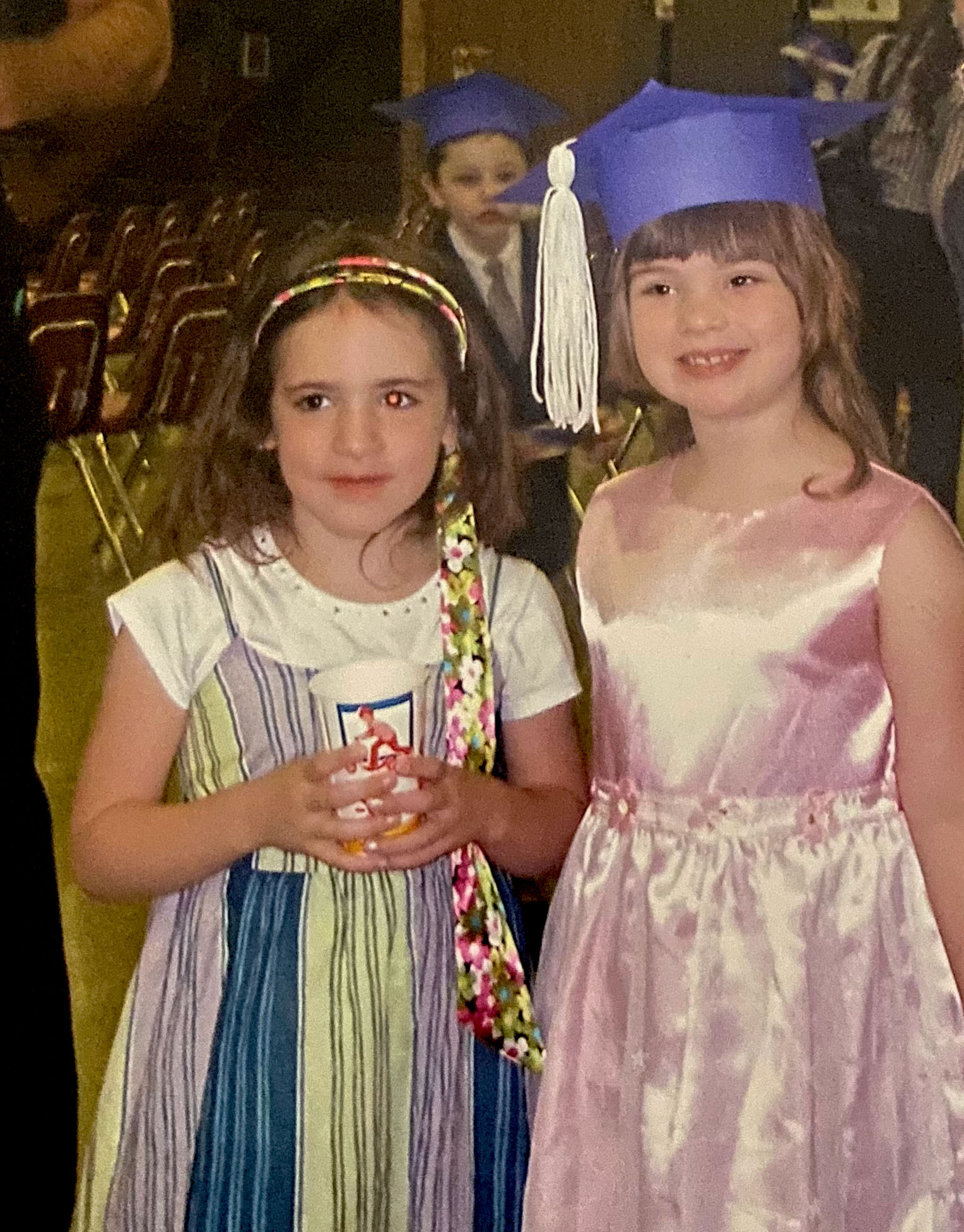 Rachel and Lauren at a childhood graduation ceremony