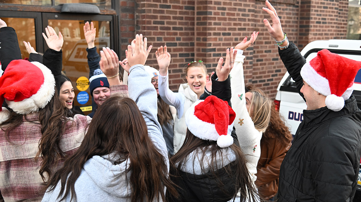 School of Education Ambassadors celebrate a successful toy drive with a group cheer