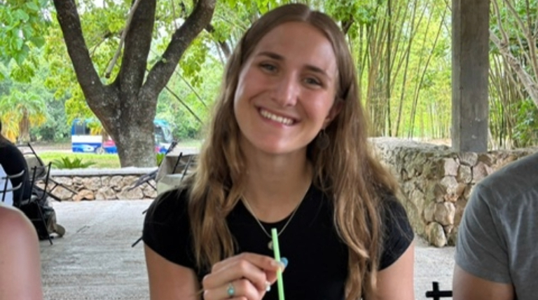 Gwen sipping coconut juice.