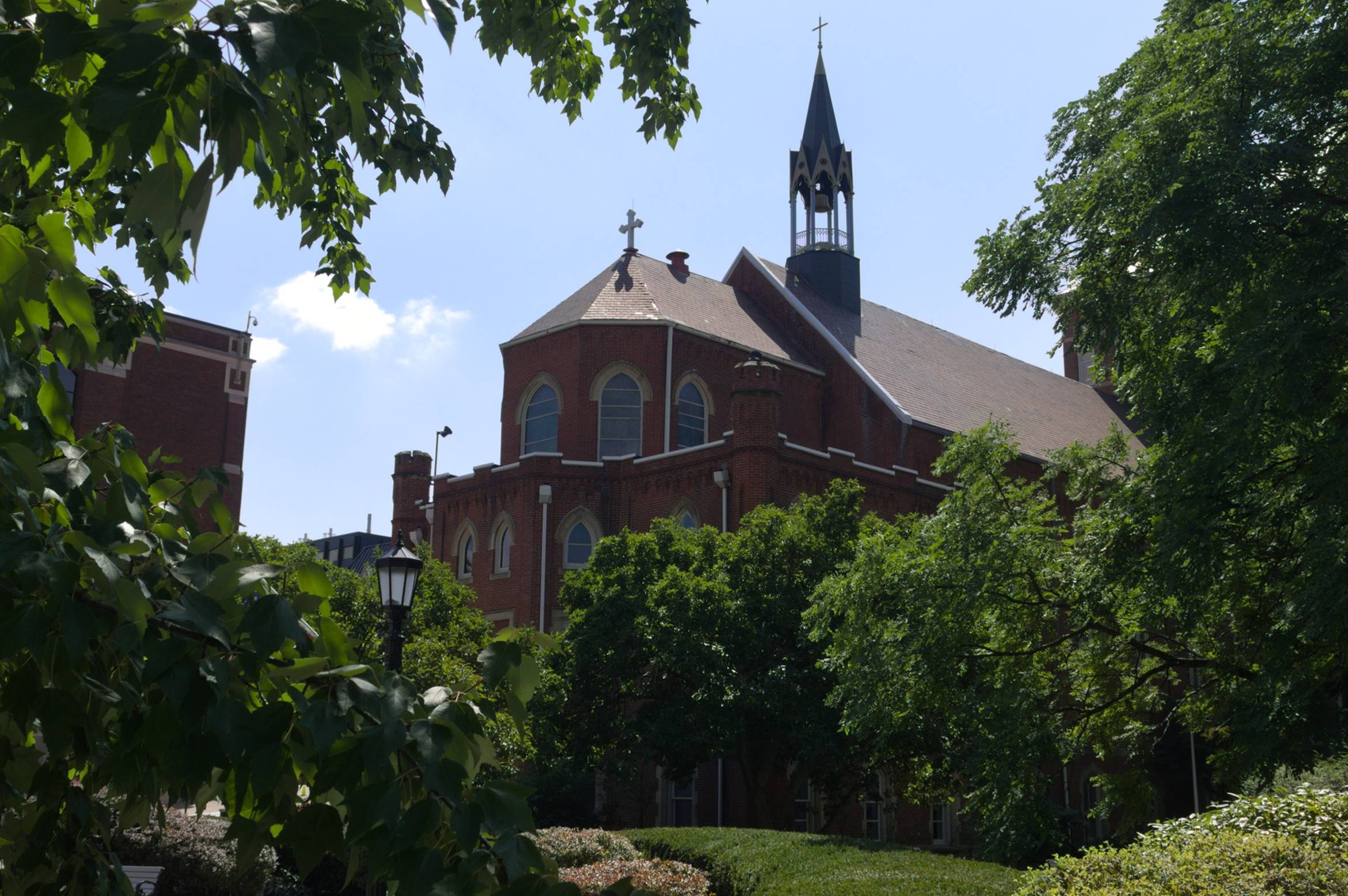 The university chapel framed by trees and gardens