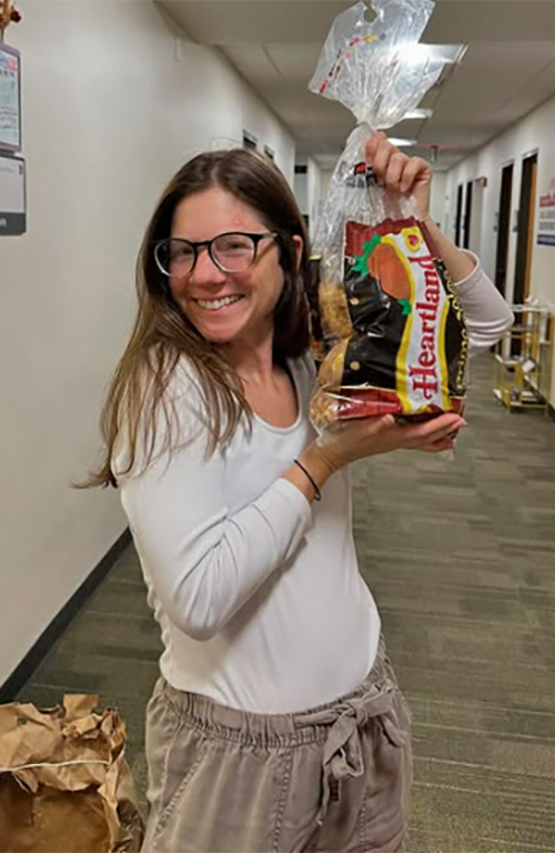 Student worker Emily Dabney outside of the McAnulty Keating Pantry