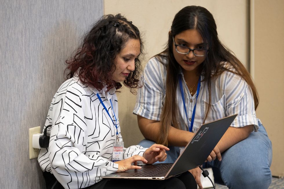 Students prepare for their presentation at Hacking4Humanity 2025