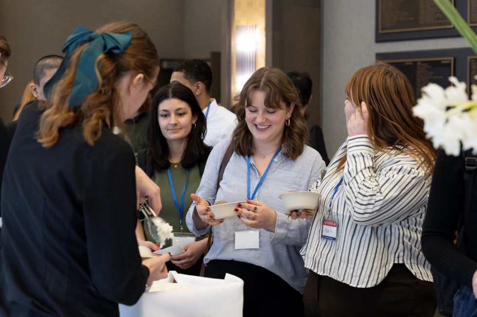 Three students in line for ice cream at Hacking4Humanity 2025