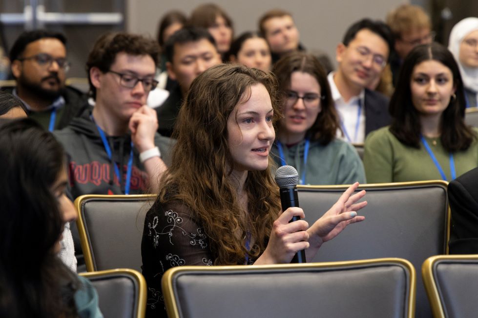 A student asks a question during the judges panel discussion