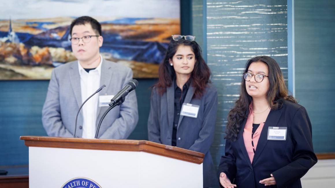 three individuals present their hackathon project at the pennsylvania governor's residence in march 2025