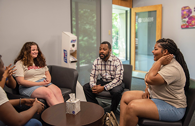 Executive Director Quincy Stephenson talking with students in The Center