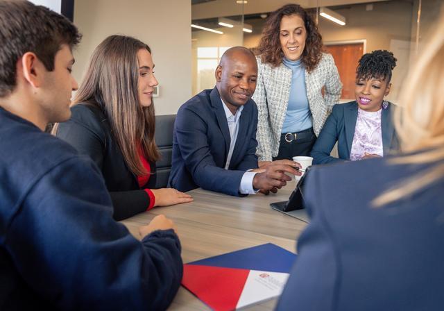 Duquesne business students meeting in a conference room.