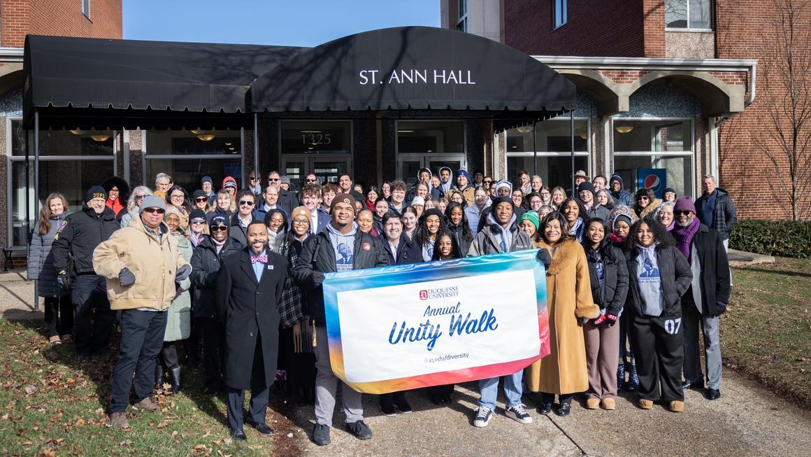 MLK Unity Walk 2026 participants group photo outside of St. Ann Hall