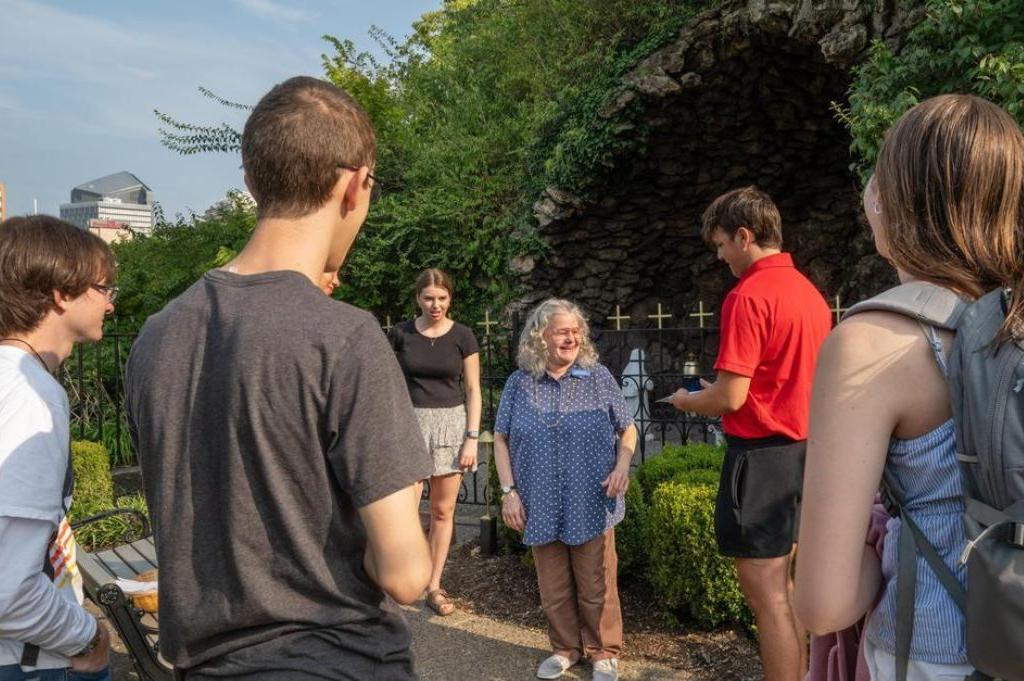 Students gather at the Lourdes Grotto for prayer and community
